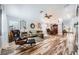 Spacious living and dining area with wood-look flooring, natural light, and stylish furnishings at 4361 Valley Quail Way, North Las Vegas, NV 89084