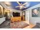 Cozy living room featuring a wooden TV cabinet, ceiling fan, and movie posters at 4361 Valley Quail Way, North Las Vegas, NV 89084