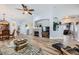 Bright open-concept space with wood flooring featuring a fireplace, dining area, and a stylish glass coffee table at 4361 Valley Quail Way, North Las Vegas, NV 89084