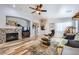 Open-concept living room showcasing a stone fireplace, wood-look floors, and a comfortable seating area at 4361 Valley Quail Way, North Las Vegas, NV 89084