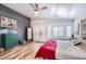 Bright bedroom boasts wood-look flooring, a bay window, ceiling fan and charming vintage-style decor at 4361 Valley Quail Way, North Las Vegas, NV 89084