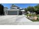Charming two-story home features a gray facade, well-maintained landscaping, and a spacious two-car garage at 4385 Newhaven Dr, Las Vegas, NV 89147