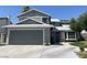 Charming two-story home features a gray facade, well-maintained landscaping, and a spacious two-car garage at 4385 Newhaven Dr, Las Vegas, NV 89147