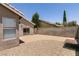 Backyard with a gravel and concrete space, enclosed by walls and lush foliage at 4825 White Aspen Ave, Las Vegas, NV 89130