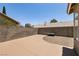 Backyard with large concrete area, decorative gravel and mature foliage around perimeter at 4825 White Aspen Ave, Las Vegas, NV 89130