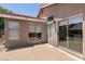 Backyard with large patio doors opening to a concrete patio and a gravel-covered landscape at 4825 White Aspen Ave, Las Vegas, NV 89130