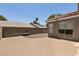 Backyard with a concrete patio and desert landscaping enclosed by a block fence for privacy at 4825 White Aspen Ave, Las Vegas, NV 89130