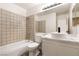 Bright bathroom featuring a tub and shower combination, modern fixtures, and vanity with a vessel sink at 4825 White Aspen Ave, Las Vegas, NV 89130