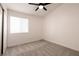 Neutral bedroom with carpet flooring, ceiling fan, and a window providing natural light at 4825 White Aspen Ave, Las Vegas, NV 89130