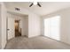 Sun-lit bedroom with neutral carpeting and a sliding door, perfect for a guest room or home office at 4825 White Aspen Ave, Las Vegas, NV 89130