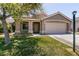 Inviting home with a manicured lawn, two-car garage, and attractive desert landscaping at 4825 White Aspen Ave, Las Vegas, NV 89130