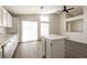 Open-concept kitchen with an island, modern lighting, and sliding glass doors to the outdoor area at 4825 White Aspen Ave, Las Vegas, NV 89130