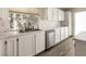 Bright kitchen with white cabinets, stainless steel appliances, and a large window overlooking the backyard at 4825 White Aspen Ave, Las Vegas, NV 89130