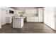 Kitchen featuring white cabinets, quartz countertops, stainless steel appliances, and center island at 4825 White Aspen Ave, Las Vegas, NV 89130