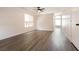 Bright and spacious living room featuring modern flooring, a ceiling fan, and lots of natural light at 4825 White Aspen Ave, Las Vegas, NV 89130