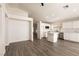 Bright, open-concept living space with hardwood floors, white cabinets and an eat-in kitchen island at 4825 White Aspen Ave, Las Vegas, NV 89130