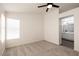 Bright bedroom with a ceiling fan and an ensuite bathroom featuring double sinks and ample counter space at 4825 White Aspen Ave, Las Vegas, NV 89130