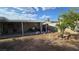 Backyard with covered patio, potential gardening area, and mature foliage at 5209 Del Monte Ave, Las Vegas, NV 89146