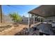 Backyard with covered patio, garden space and block wall fencing, offering a private oasis at 5209 Del Monte Ave, Las Vegas, NV 89146