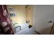 Compact bathroom including a tub-shower combo with seating and safety bars at 5209 Del Monte Ave, Las Vegas, NV 89146