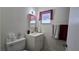 Well-lit bathroom featuring a vanity, toilet, mirror, and decorative window at 5209 Del Monte Ave, Las Vegas, NV 89146