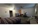 Spacious bedroom featuring a ceiling fan, a bed, and open closet space at 5209 Del Monte Ave, Las Vegas, NV 89146