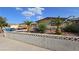 A charming one-story house is surrounded by low-maintenance desert landscaping and a privacy wall at 5209 Del Monte Ave, Las Vegas, NV 89146