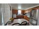Bright kitchen featuring stainless steel appliances, tile backsplash, and dining area at 5209 Del Monte Ave, Las Vegas, NV 89146