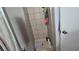 Tiled shower with mounted caddy and neutral colored tiled walls at 5209 Del Monte Ave, Las Vegas, NV 89146