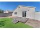 This backyard offers a small, wooden deck, a patch of lawn, and rock landscaping at 5912 Kentlands St, Las Vegas, NV 89130