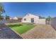 This backyard offers a small, wooden deck, a patch of lawn, and rock landscaping at 5912 Kentlands St, Las Vegas, NV 89130