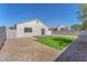 This backyard offers a small, wooden deck, a patch of lawn, and rock landscaping at 5912 Kentlands St, Las Vegas, NV 89130