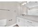 Bathroom with a modern vanity, featuring sleek white cabinets, a stylish faucet, and a well-lit mirror at 5912 Kentlands St, Las Vegas, NV 89130