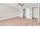 Bedroom with wood-look floors features an en-suite bathroom, plus a ceiling fan for added comfort at 5912 Kentlands St, Las Vegas, NV 89130