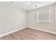 Cozy bedroom with hardwood floors, neutral paint and natural light from a window at 5912 Kentlands St, Las Vegas, NV 89130