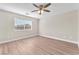 Light-filled bedroom featuring wood-look flooring and ceiling fan, with a window bringing in natural light at 5912 Kentlands St, Las Vegas, NV 89130