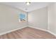 Cozy bedroom with hardwood floors, neutral paint and natural light from a window at 5912 Kentlands St, Las Vegas, NV 89130