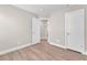 Bright bedroom with wood-look floors, white trim and neutral walls, plus a view into the hallway at 5912 Kentlands St, Las Vegas, NV 89130
