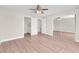Spacious bedroom features wood-look floors, adjacent bathroom, and large mirrored closet for ample storage at 5912 Kentlands St, Las Vegas, NV 89130