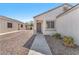 A gray front door is centered in the image with desert landscaping and an attached garage nearby at 5912 Kentlands St, Las Vegas, NV 89130