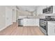 Kitchen with white cabinets, stainless steel appliances, stone countertops, and an open layout at 5912 Kentlands St, Las Vegas, NV 89130