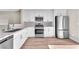 Well-lit kitchen featuring stainless steel appliances, white cabinets, and stone countertops at 5912 Kentlands St, Las Vegas, NV 89130