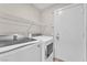 Convenient laundry area featuring modern washer and dryer, plus wire shelving for storage at 5912 Kentlands St, Las Vegas, NV 89130