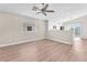 Bright living room with hardwood floors, neutral paint, a window, and modern ceiling fan at 5912 Kentlands St, Las Vegas, NV 89130