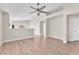 Bright living room with hardwood floors, neutral paint, and a modern ceiling fan at 5912 Kentlands St, Las Vegas, NV 89130