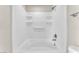 Clean and modern bathtub and shower combination with sleek fixtures, shelves, and neutral walls at 5912 Kentlands St, Las Vegas, NV 89130