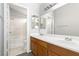 Bathroom featuring double sinks, large mirror, and bath with shower at 6112 Grape Blossom Ave, Las Vegas, NV 89142