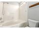 Full bathroom features white tile, bathtub and shower, and standard toilet at 6112 Grape Blossom Ave, Las Vegas, NV 89142