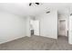 Large bedroom with neutral walls, carpeted floor, ceiling fan and ensuite bath at 6112 Grape Blossom Ave, Las Vegas, NV 89142