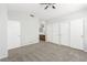 Spacious bedroom with carpeted floor, ceiling fan, and large closets at 6112 Grape Blossom Ave, Las Vegas, NV 89142